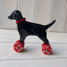 Load image into Gallery viewer, Black Labrador Ceramic &quot;Woof on Wheels&quot; Ornament
