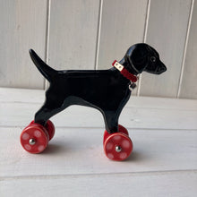 Load image into Gallery viewer, Black Labrador Ceramic &quot;Woof on Wheels&quot; Ornament
