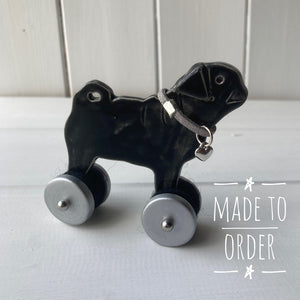 Black Pug "Woof on Wheels" ceramic ornament