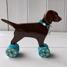 Load image into Gallery viewer, Chocolate Labrador Ceramic &quot;Woof on Wheels&quot; Ornament
