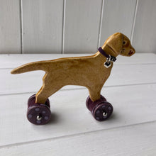 Load image into Gallery viewer, Yellow Labrador Ceramic &quot;Woof on Wheels&quot; Ornament
