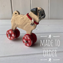 Load image into Gallery viewer, Pug &quot;Woof on Wheels&quot; ceramic ornament
